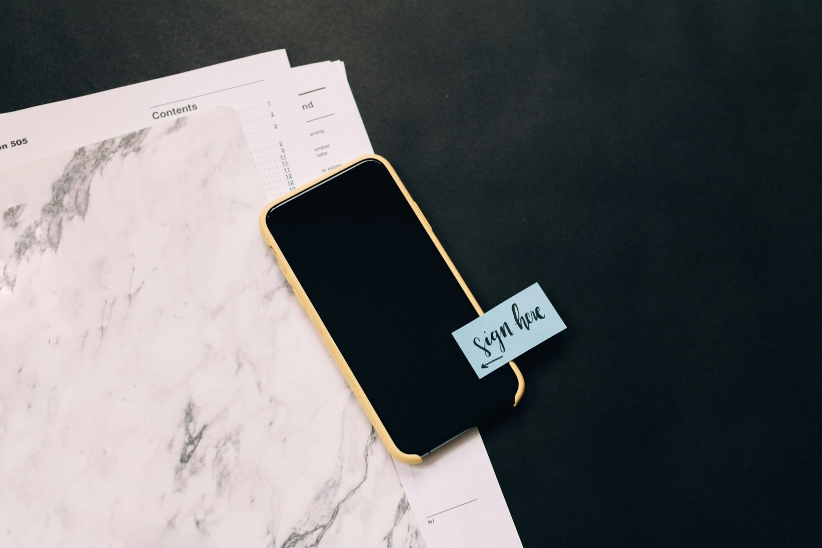 Taxes for Self-Employed Business Owners: black smartphone on white pad