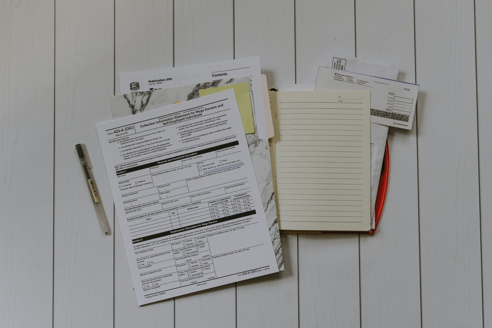 Understanding Taxes For Travel Nurses in California: stack of papers flat lay photography