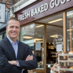 LLC Distributions: a man standing in front of a bakery