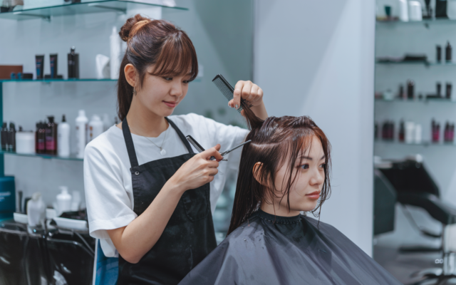 a woman getting her hair cut